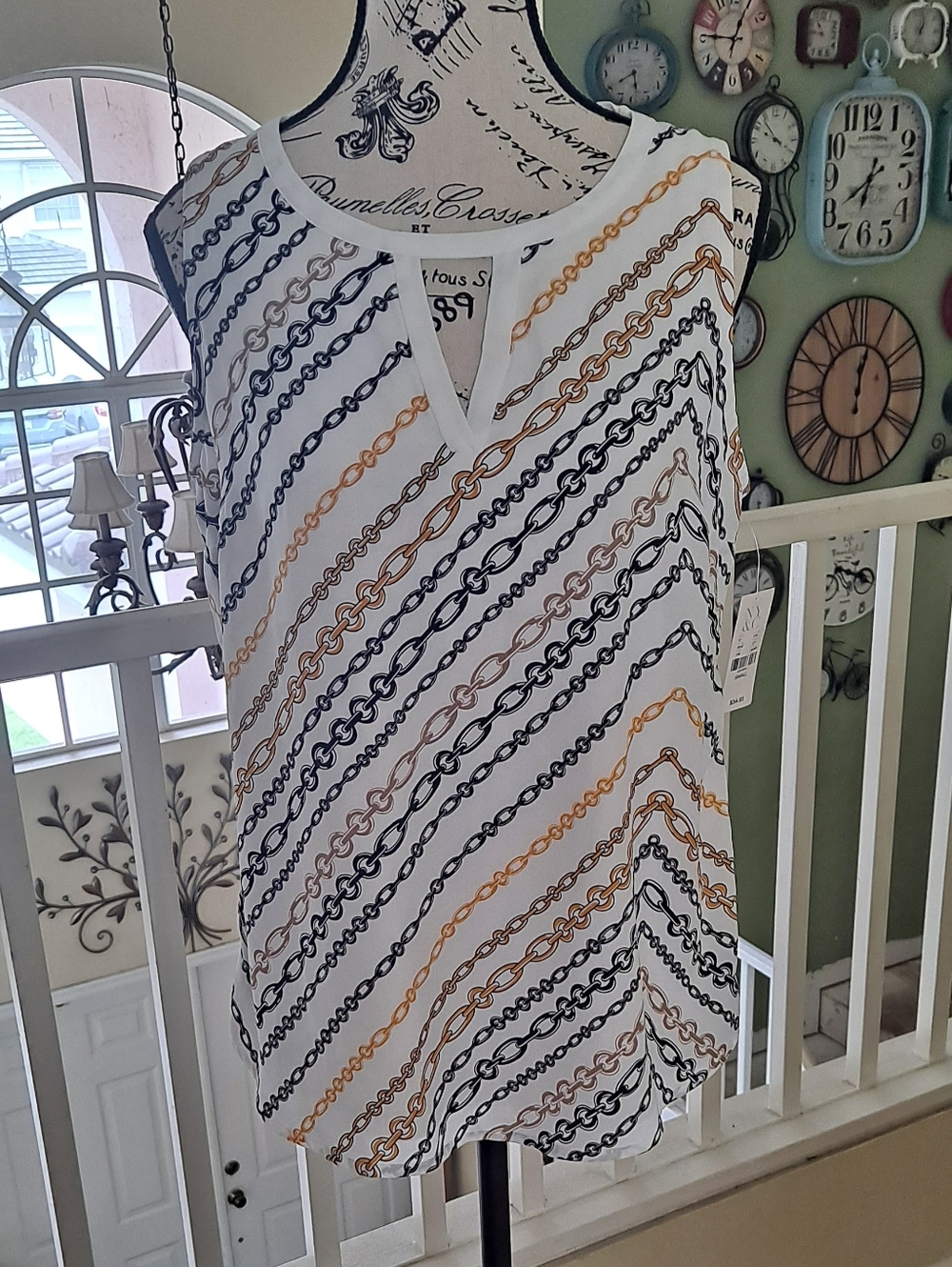 NY & co Sleeveless Chain-Print Split-Neck Top in White with Black & Gold Chains.